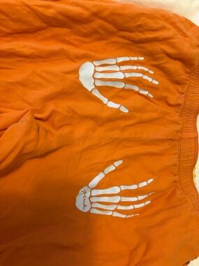 PINK Victoria's Secret Orange Pants with White Skeleton Hand Print